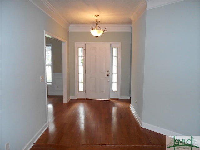 foyer entrance with dark hardwood / wood-style flooring and ornamental molding