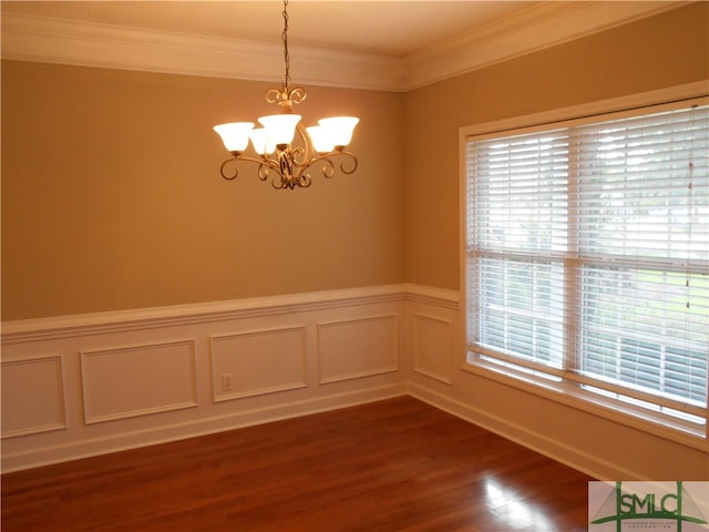 unfurnished room with a chandelier, ornamental molding, a wealth of natural light, and dark hardwood / wood-style floors