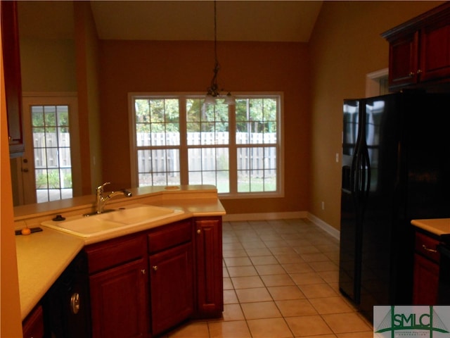 kitchen with black appliances, sink, light tile patterned floors, and plenty of natural light