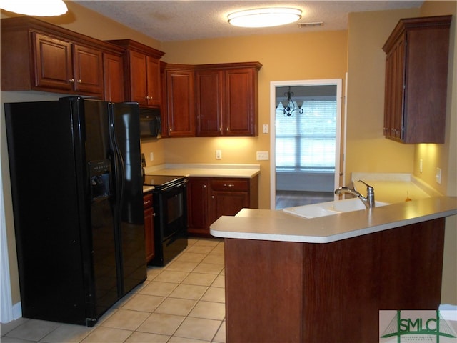 kitchen featuring an inviting chandelier, kitchen peninsula, black appliances, a textured ceiling, and light tile patterned flooring