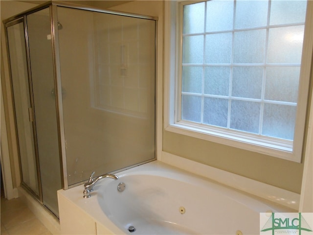 bathroom featuring tile patterned flooring and shower with separate bathtub