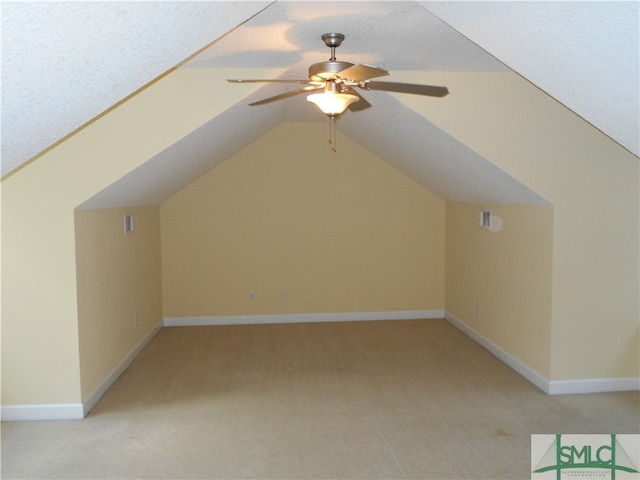 bonus room featuring ceiling fan, a textured ceiling, light carpet, and vaulted ceiling