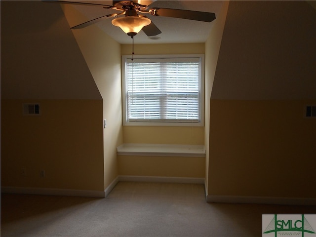 additional living space featuring light colored carpet, lofted ceiling, and ceiling fan