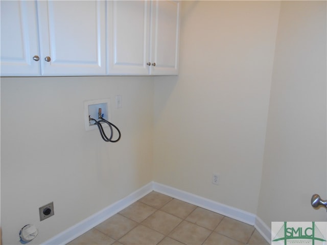 clothes washing area with cabinets, hookup for a washing machine, light tile patterned floors, and electric dryer hookup