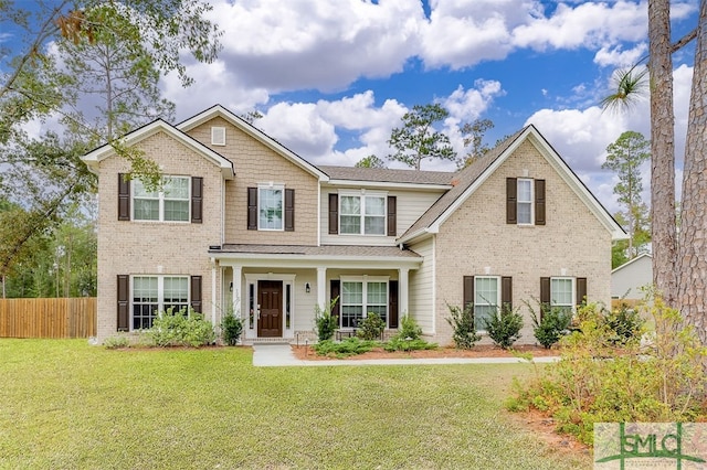 view of front of house with covered porch and a front lawn