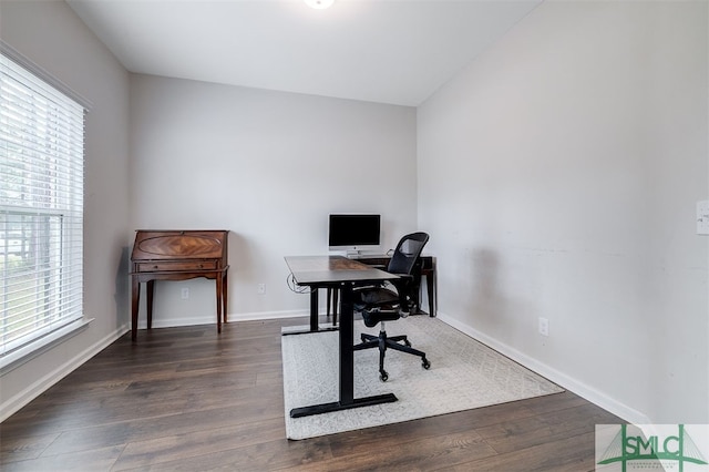 office with dark wood-type flooring and a healthy amount of sunlight