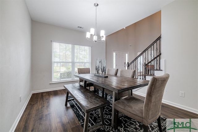 dining space featuring dark hardwood / wood-style flooring and a chandelier