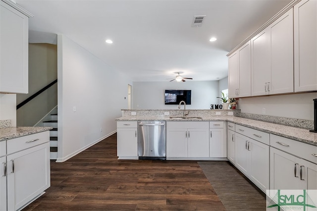 kitchen with white cabinets, sink, stainless steel dishwasher, dark hardwood / wood-style floors, and light stone countertops