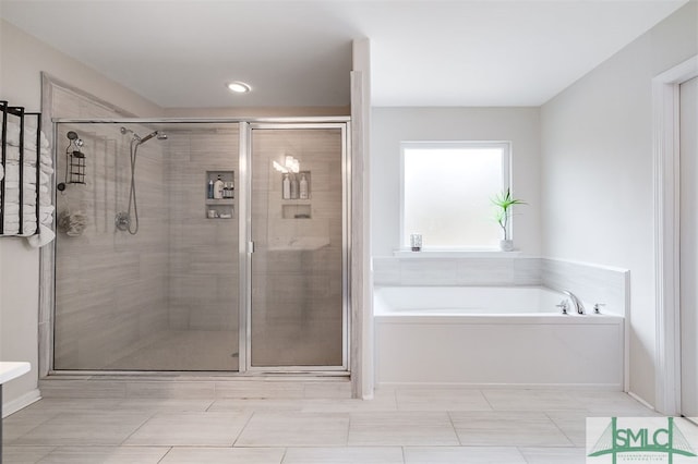 bathroom featuring independent shower and bath