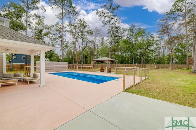 view of pool with a patio, a yard, and a gazebo