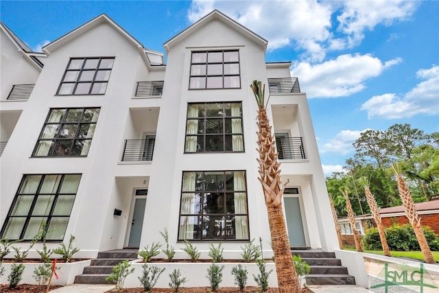 view of front of house featuring a balcony