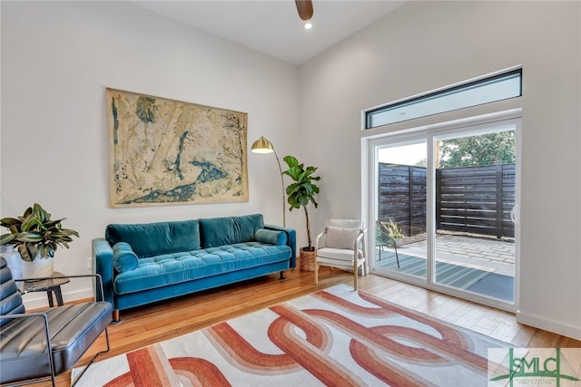 living room featuring wood-type flooring and ceiling fan