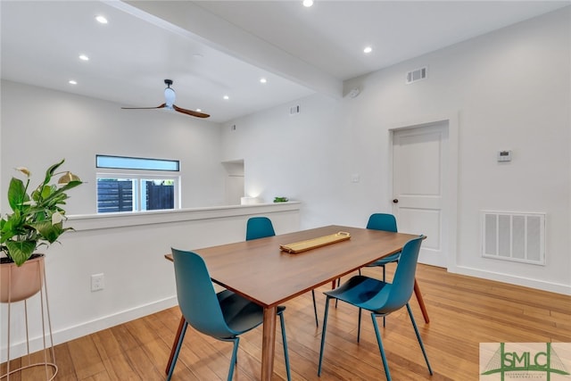 dining room with light wood-type flooring, ceiling fan, and beam ceiling