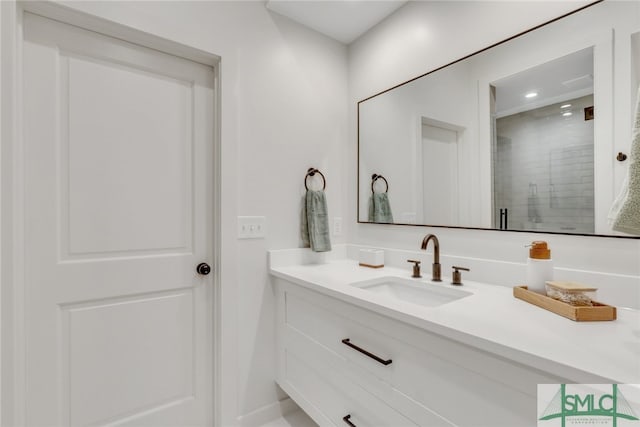 bathroom featuring vanity and a shower with door