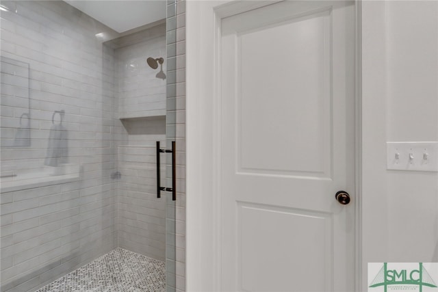 bathroom featuring a shower with shower door