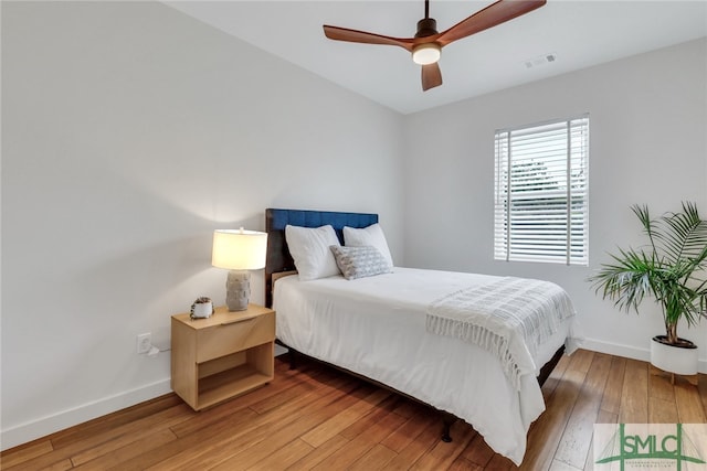 bedroom with hardwood / wood-style floors and ceiling fan