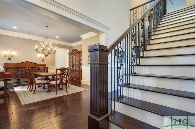 interior space with an inviting chandelier, hardwood / wood-style floors, and crown molding