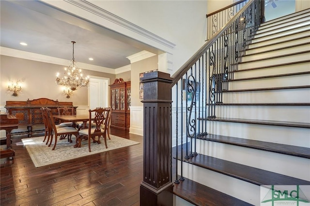 1558 Wilmington Island Rd, Savannah, GA 31410 - dining area featuring stairway, dark wood finished floors, crown molding, a chandelier, and wainscoting