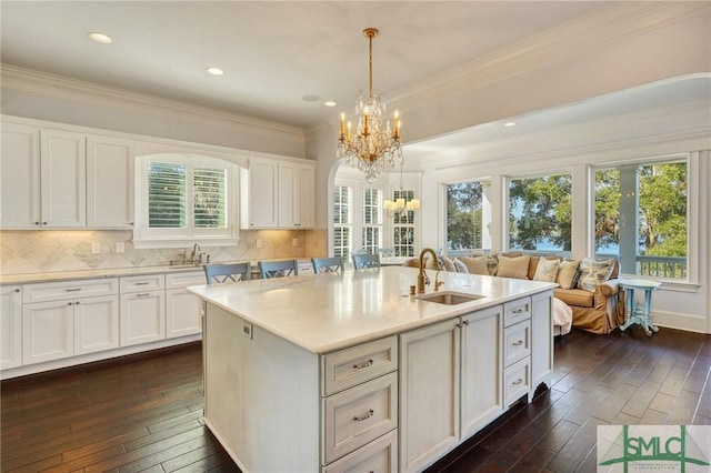 1558 Wilmington Island Rd, Savannah, GA 31410 - kitchen featuring a chandelier, dark wood finished floors, light countertops, white cabinetry, and ornamental molding