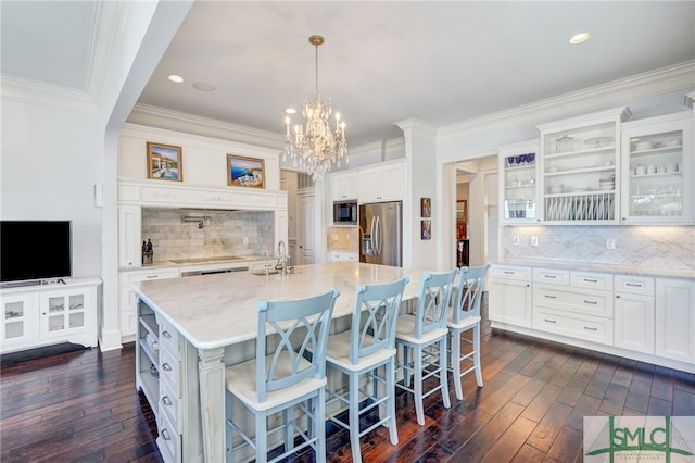 kitchen with white cabinetry, stainless steel appliances, and dark hardwood / wood-style floors