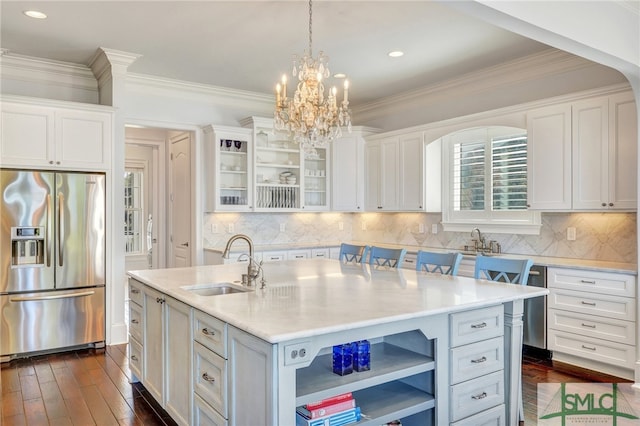 kitchen with white cabinets, stainless steel refrigerator with ice dispenser, sink, and a kitchen island with sink