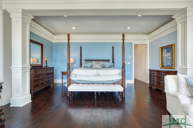 bedroom with decorative columns, hardwood / wood-style flooring, and ornamental molding