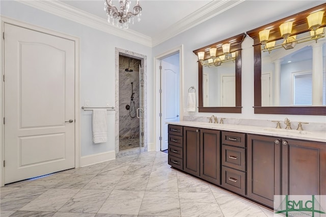 bathroom with a chandelier, decorative columns, ornamental molding, vanity, and a shower with shower door