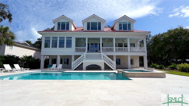 back of house featuring ceiling fan, a swimming pool with hot tub, and a patio area