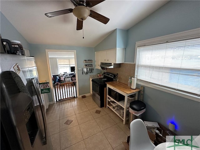 kitchen featuring stainless steel appliances, ceiling fan, light tile patterned floors, white cabinetry, and lofted ceiling