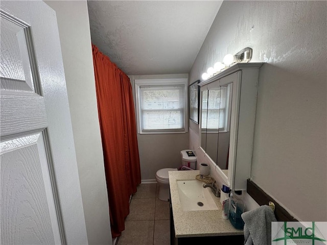 bathroom with tile patterned flooring, vanity, toilet, and lofted ceiling