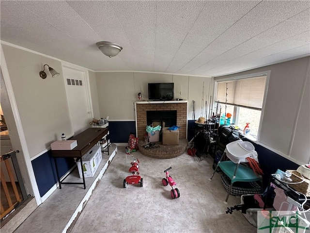 living room with a brick fireplace