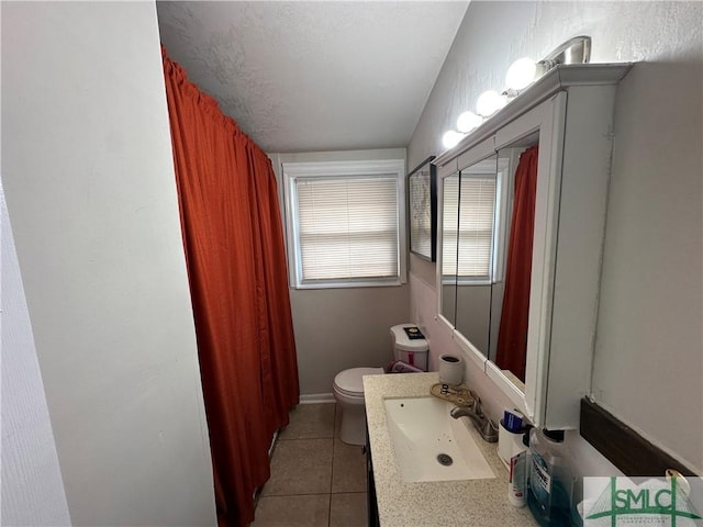 bathroom with tile patterned flooring, vanity, and toilet