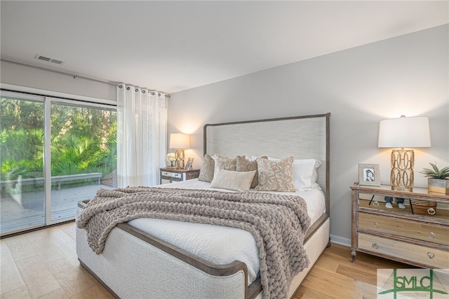 bedroom with access to exterior and light wood-type flooring