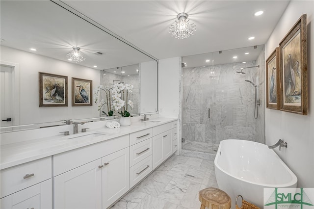 bathroom featuring a chandelier, vanity, and plus walk in shower