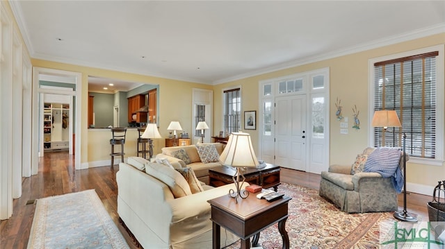 living room featuring wood-type flooring and crown molding