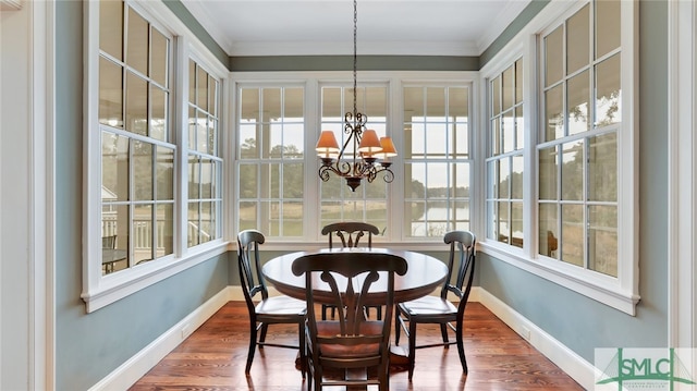 sunroom / solarium featuring plenty of natural light and an inviting chandelier