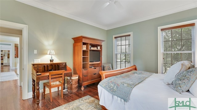 bedroom with ornamental molding, multiple windows, dark hardwood / wood-style flooring, and ceiling fan