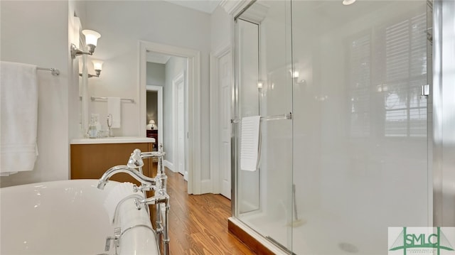 bathroom with vanity, wood-type flooring, and separate shower and tub