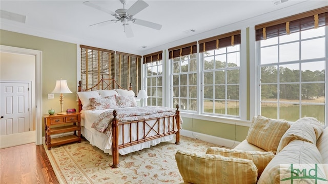 bedroom with hardwood / wood-style flooring and ceiling fan