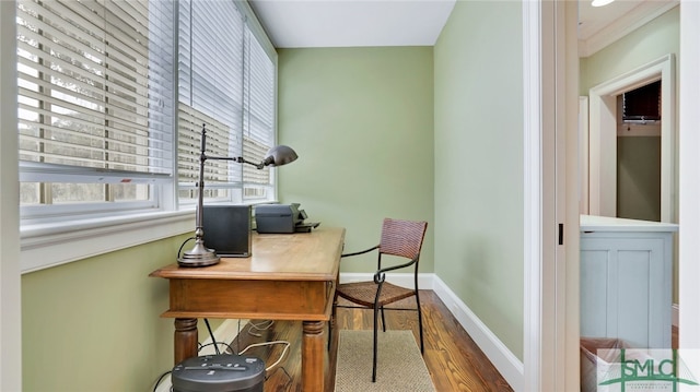 home office featuring wood-type flooring and ornamental molding