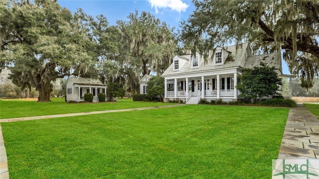 cape cod house featuring a front yard and covered porch