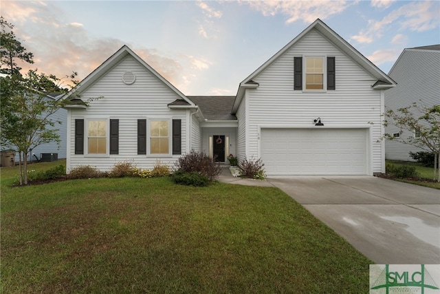 view of property featuring a lawn, cooling unit, and a garage