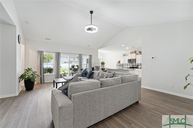 living room featuring hardwood / wood-style flooring and vaulted ceiling