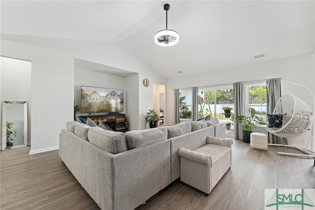 living room with vaulted ceiling and hardwood / wood-style flooring