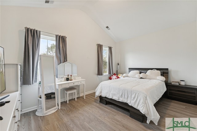 bedroom with light hardwood / wood-style flooring and vaulted ceiling