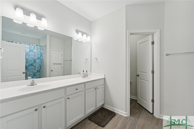 bathroom with a shower with shower curtain, wood-type flooring, and vanity