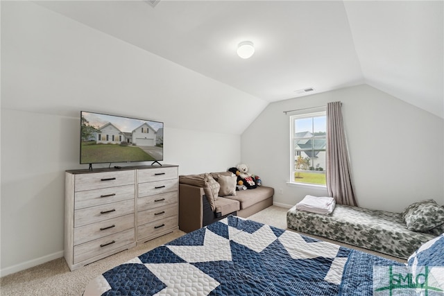 bedroom with lofted ceiling and light carpet