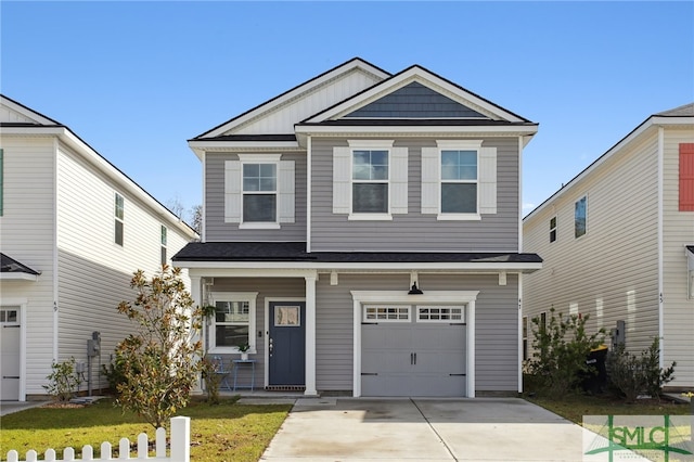 view of front of property featuring a front yard, a garage, and covered porch