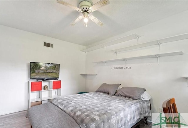 bedroom with ceiling fan and hardwood / wood-style flooring