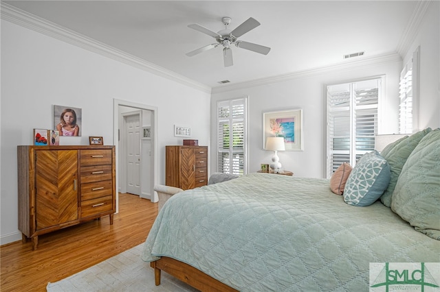 bedroom with wood-type flooring, ceiling fan, and crown molding